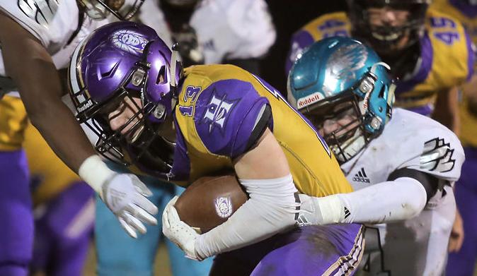 Mason Huskey is tackled by Blake Heuer
